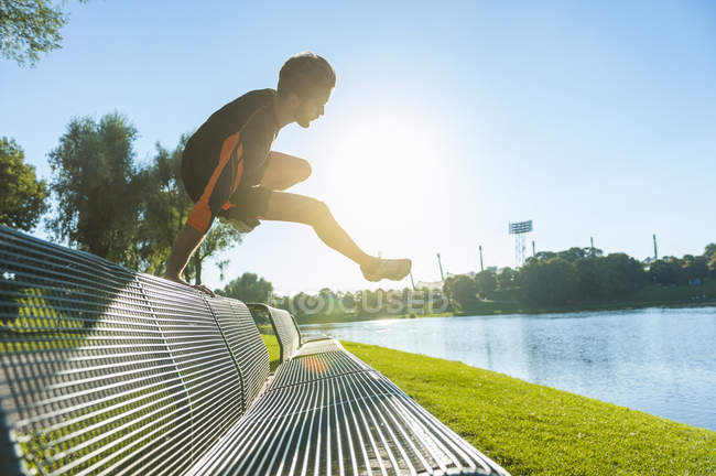 focused_173772914-stock-photo-athlete-jumping-bench-while-running.jpg